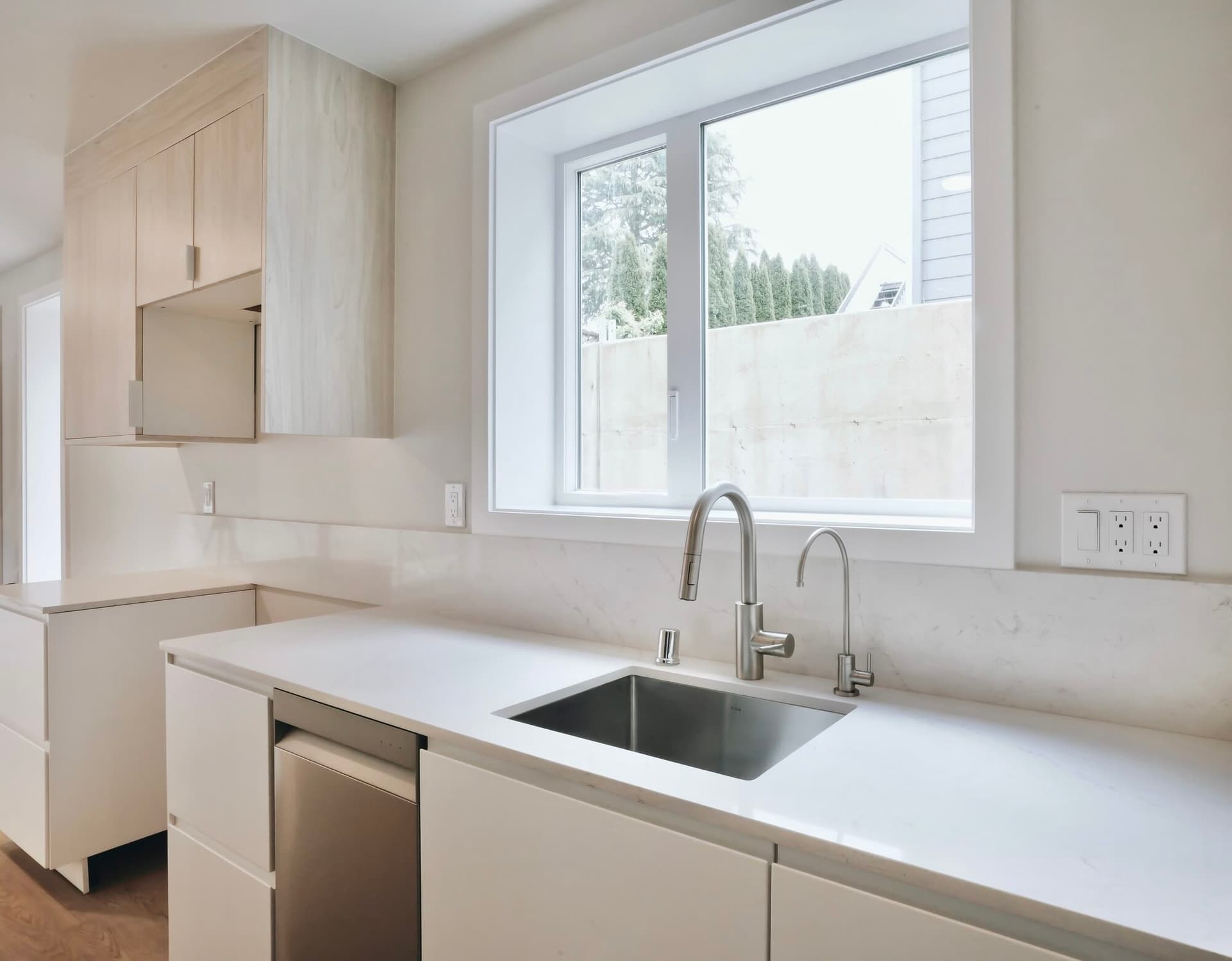 A finished bright white kitchen with flawless cabinetry and millwork by Strata Coating